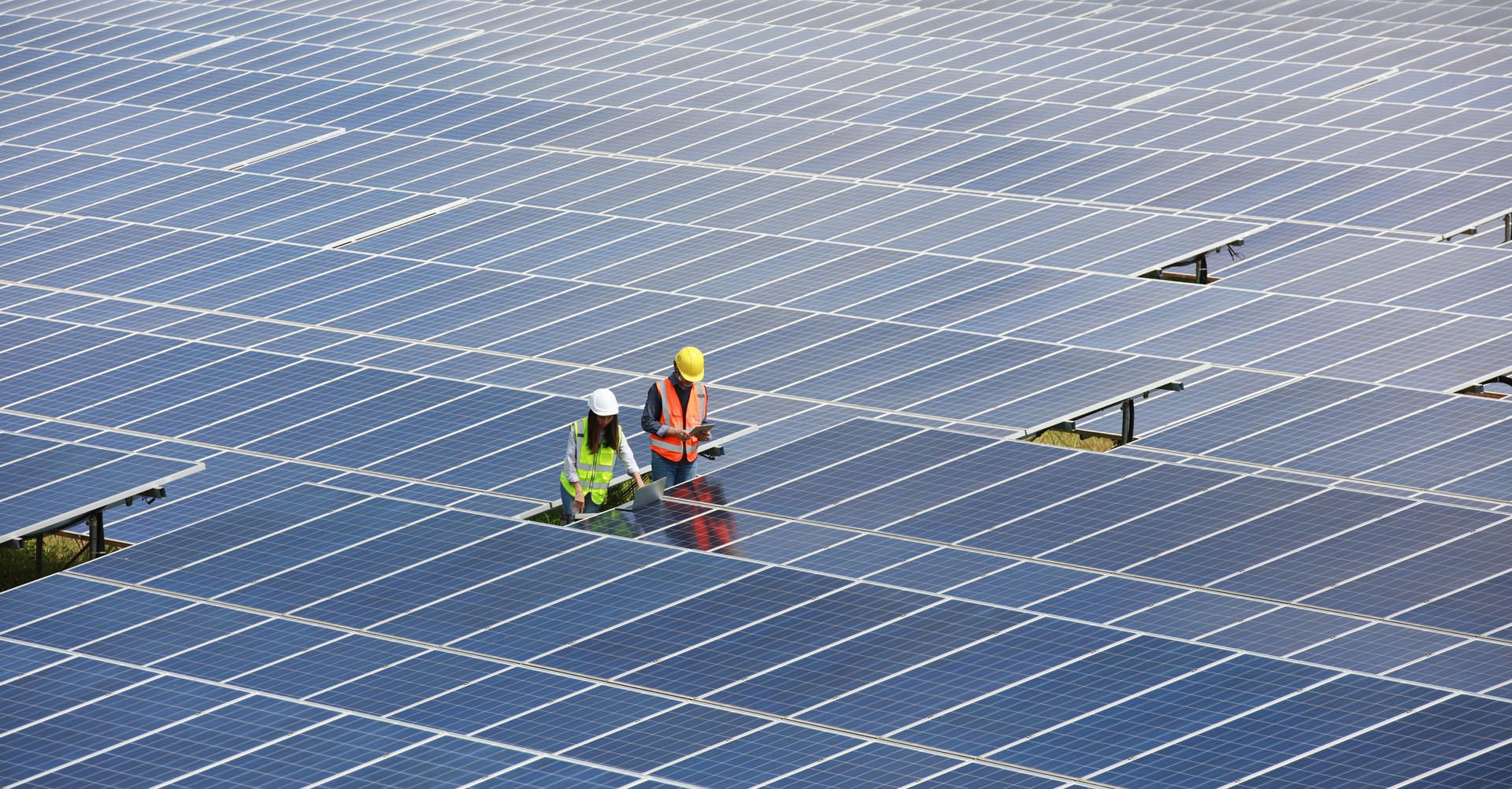 Solar Engineer wearing safety PPE work inspecting solar panel ,Renewable and Green energy concept